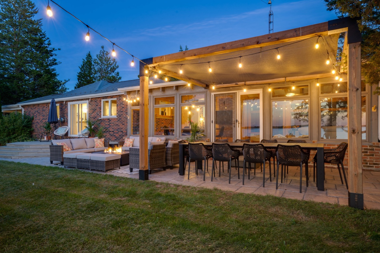 The County Casa exterior dining area under warm string lights