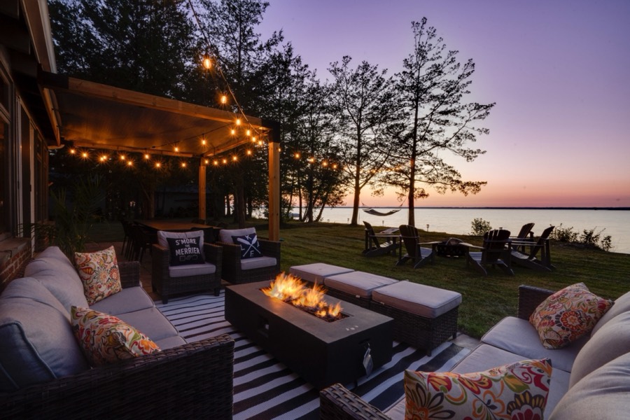 Waterfront patio and fire table at sunset