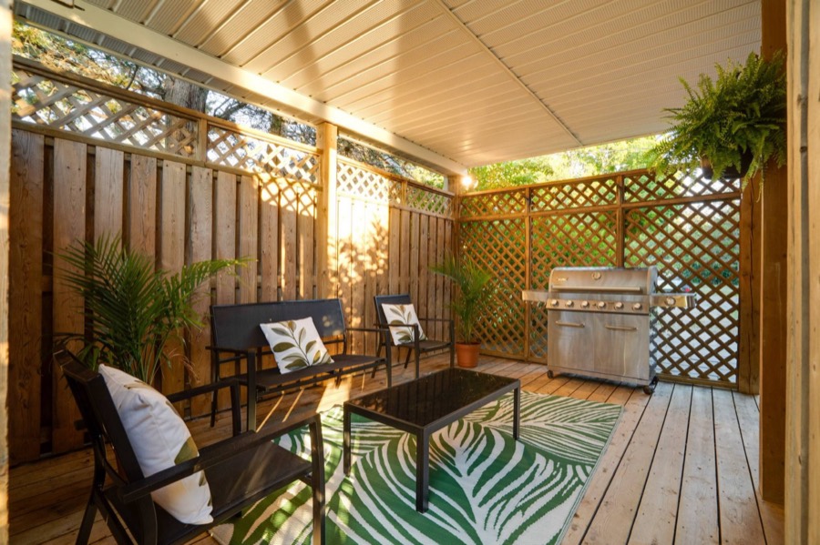 Covered private deck with seating and a six-burner barbecue