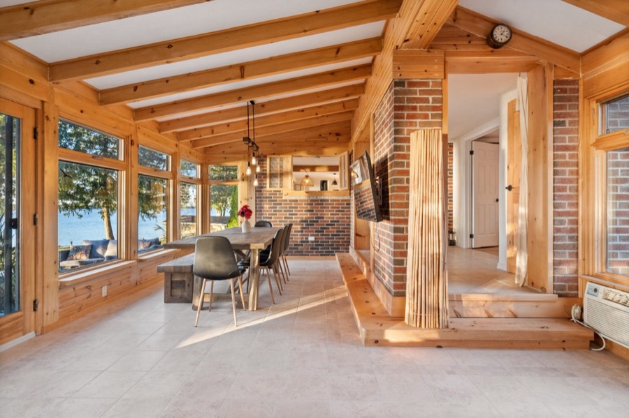 Dining area with exposed brick wall leading to the kitchen