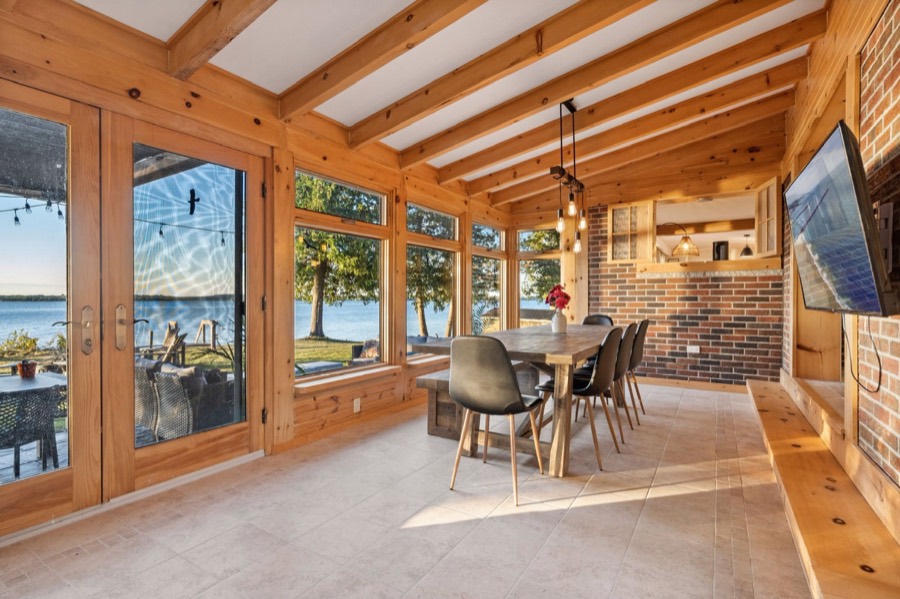 Dining area with French doors opening to the patio and water